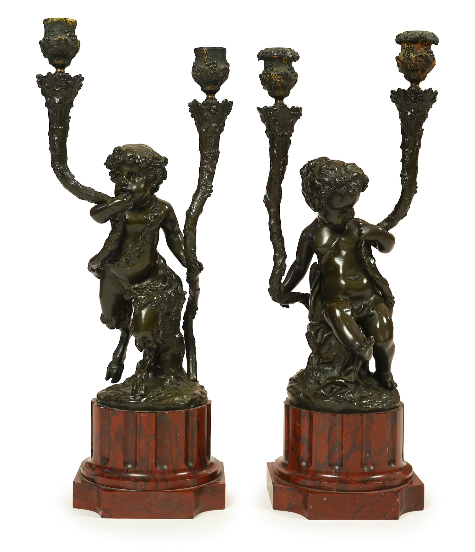 After Clodion. A pair of mid 19th century French bronze two branch figural candelabra